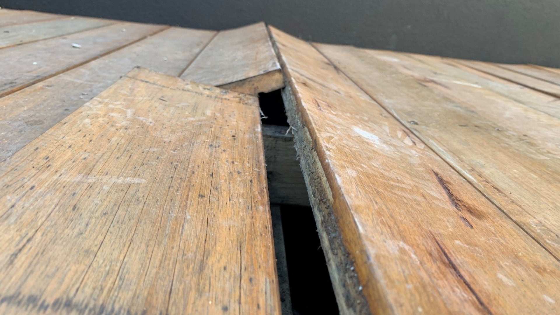 Decking boards that have warped due to poor subfloor ventilation.
