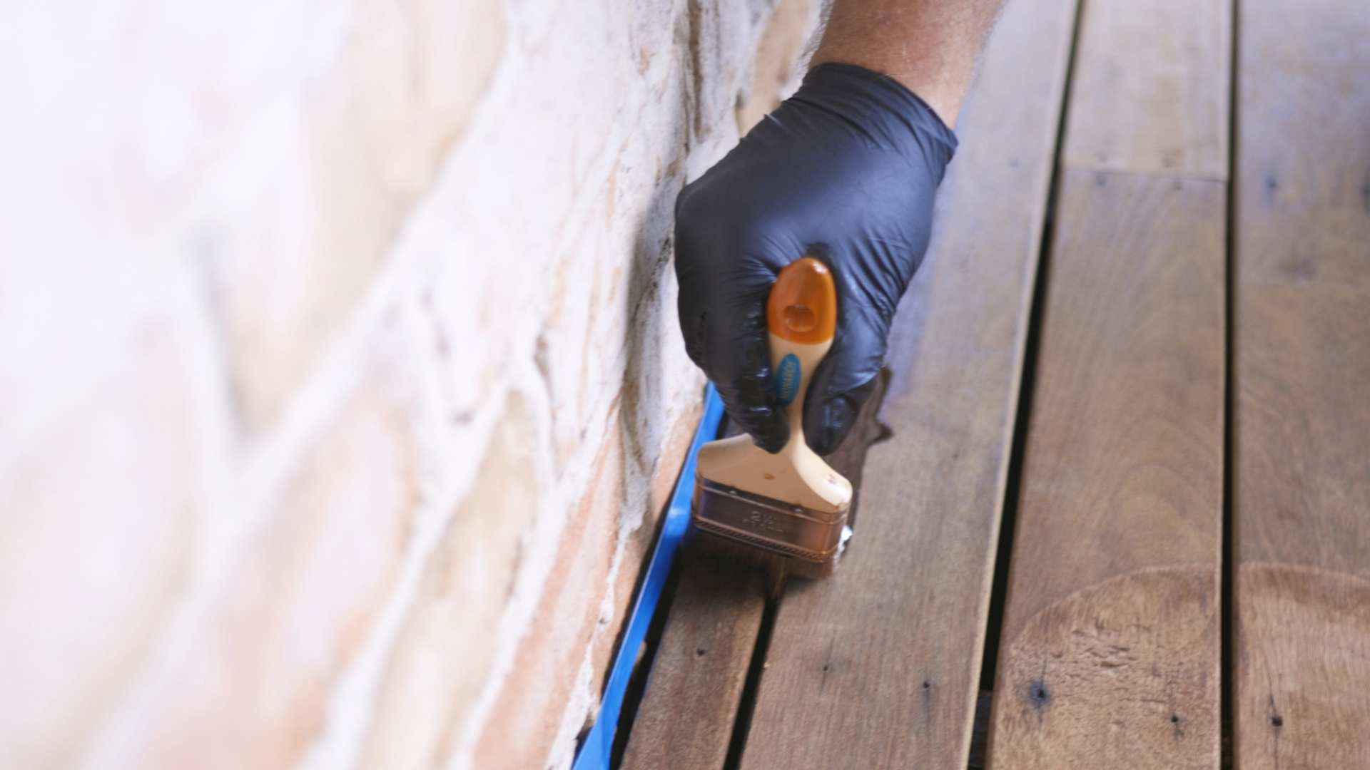 Oil application on corner board of decking.