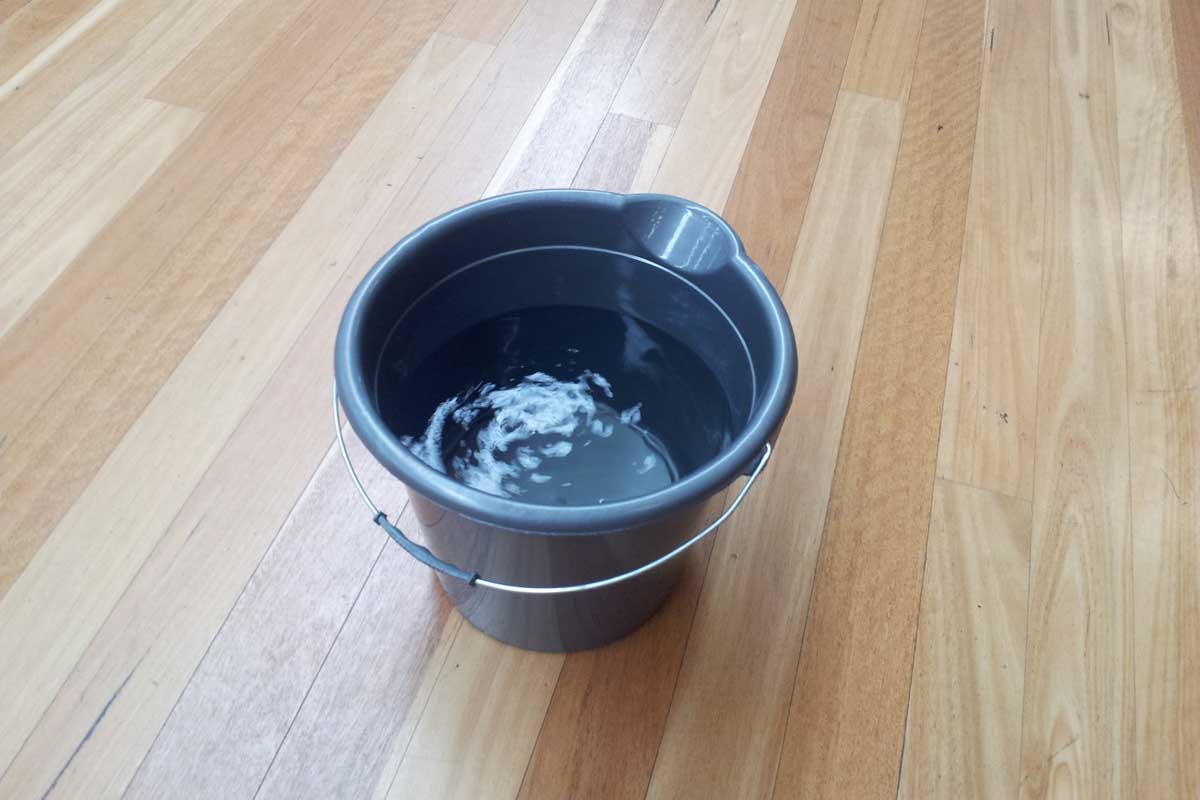 a bucket of water on the engineered flooring