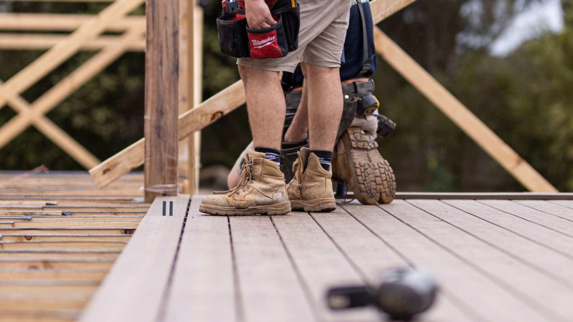 Trades installing composite decking on jobsite.