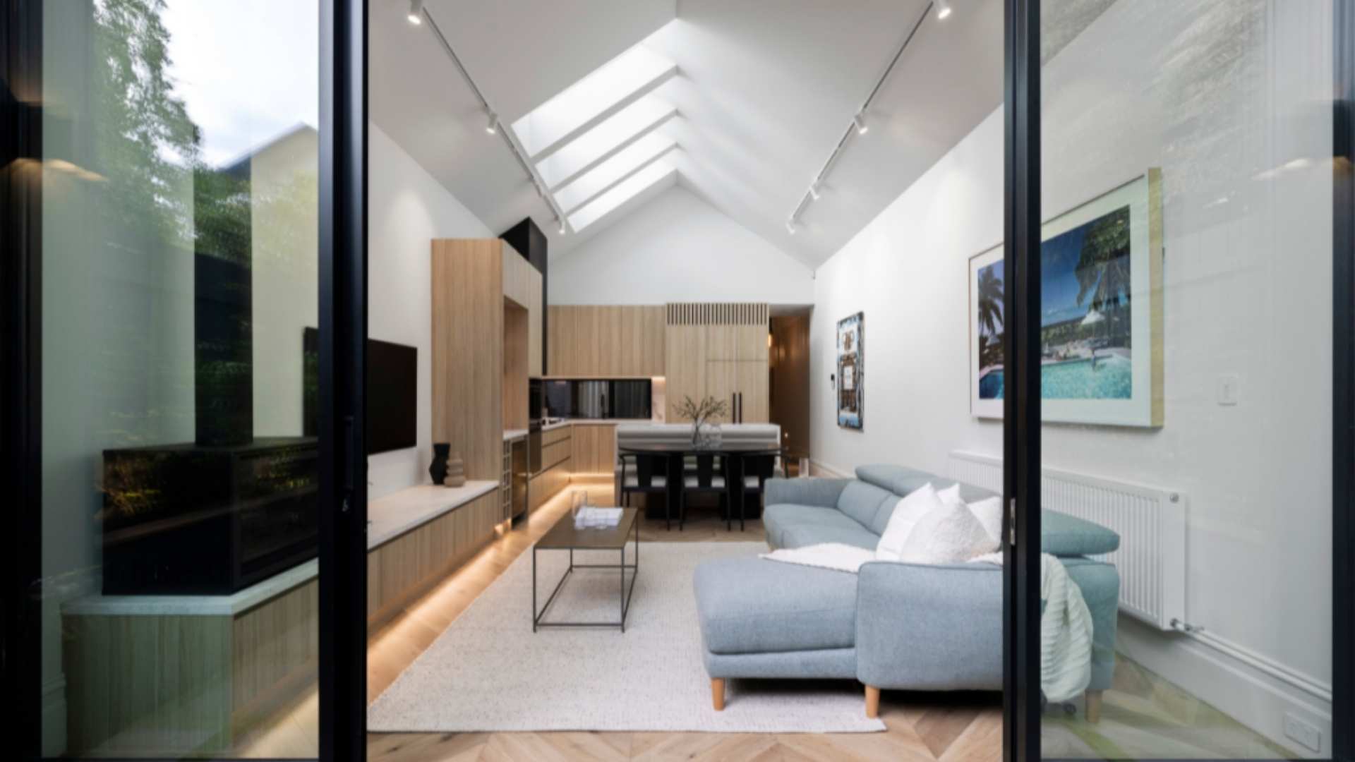 View of the living and kitchen area from the perspective of the backyard.