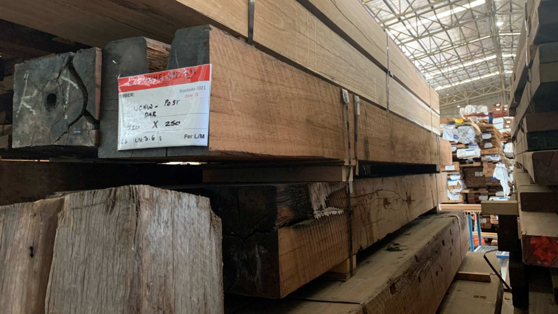 Recycled timber posts ready for delivery to customer in timber yard.