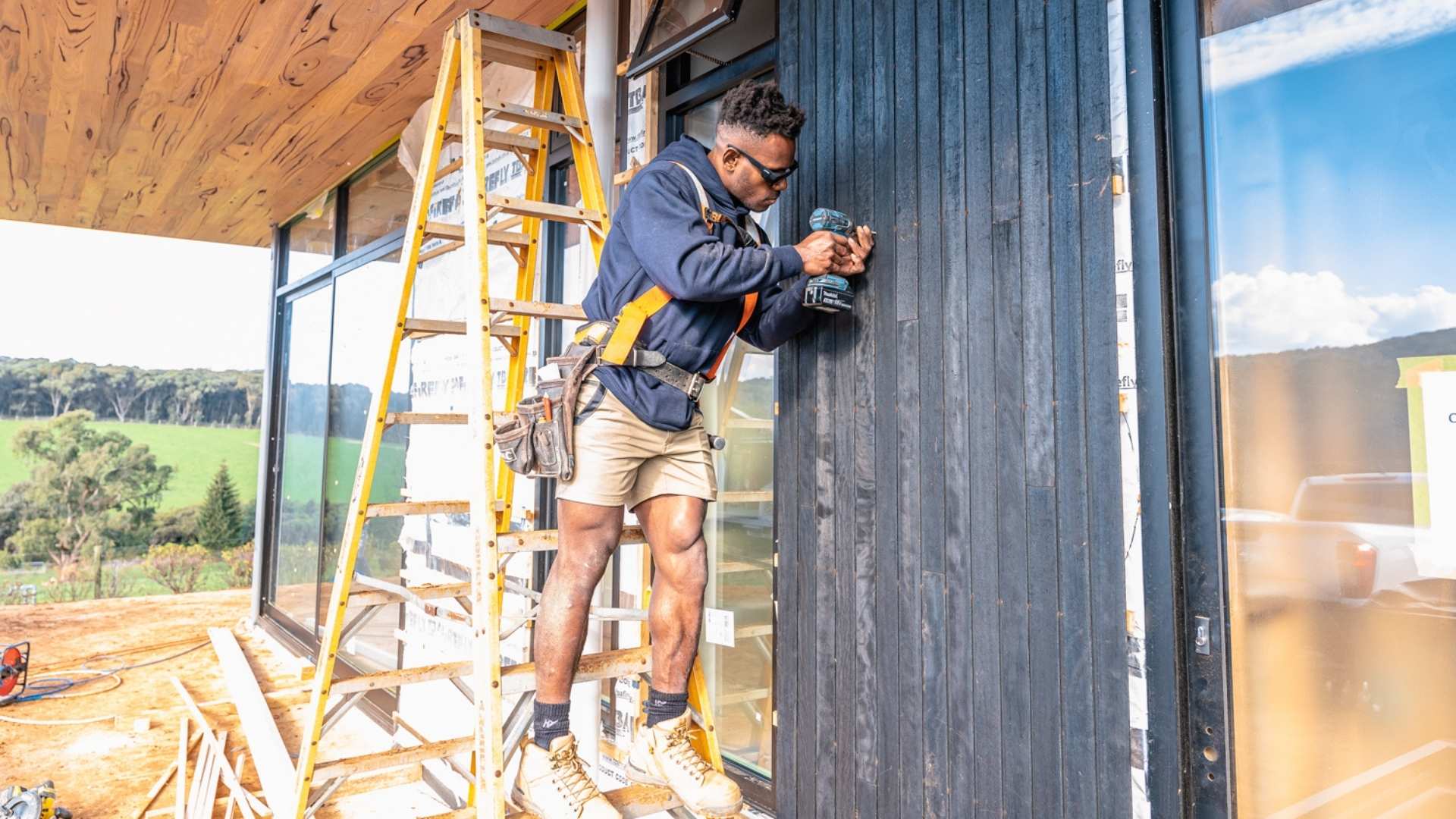 Carpenter drilling on jobsite.