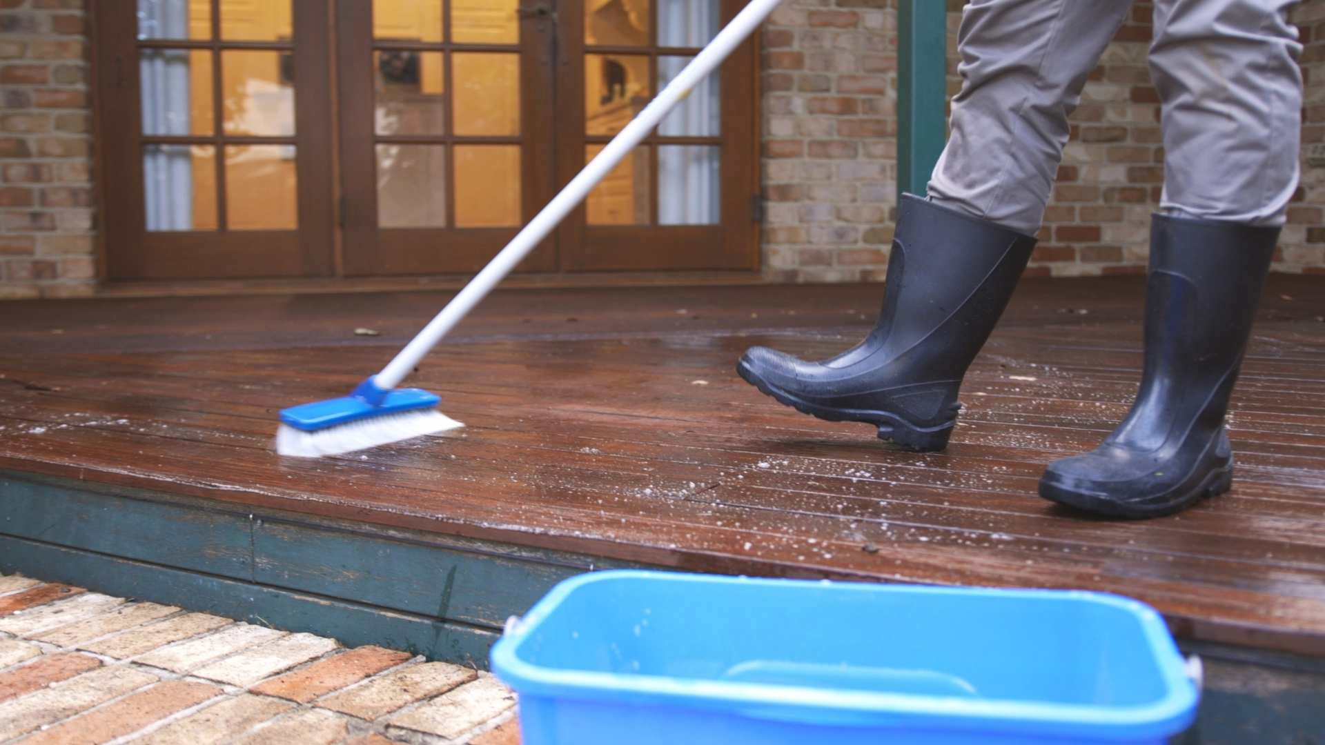 A deck being cleaned as water is being pushed off.