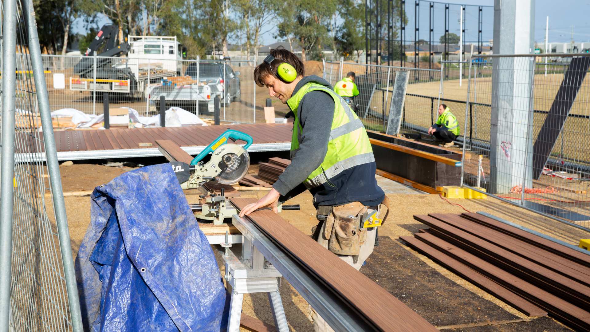 A man using a circular saw on a deck, being aware of the HIA's discussion regarding the changes and challenges faced by NCC.