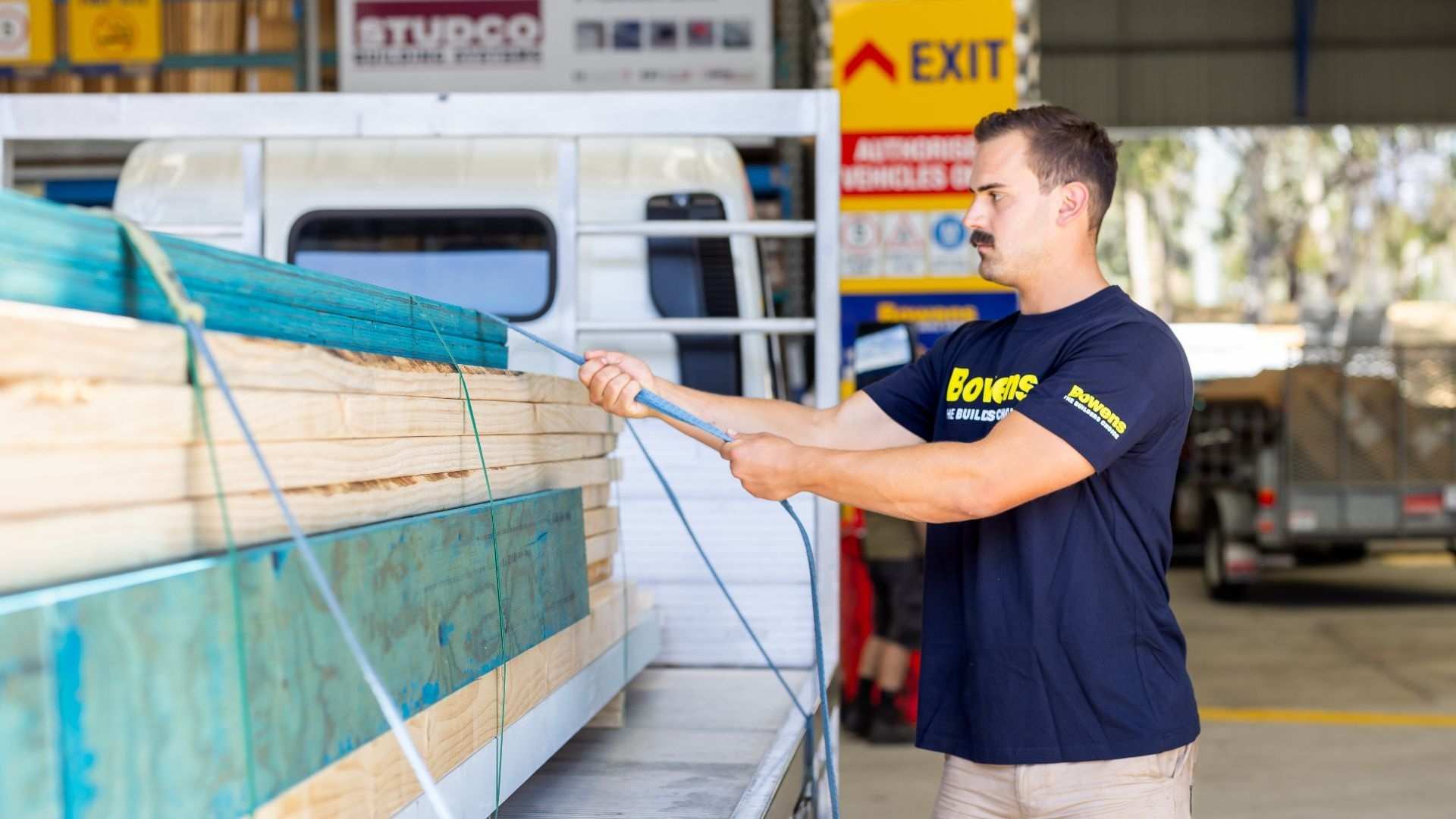 Trade strapping down timber on truck ready for delivery.