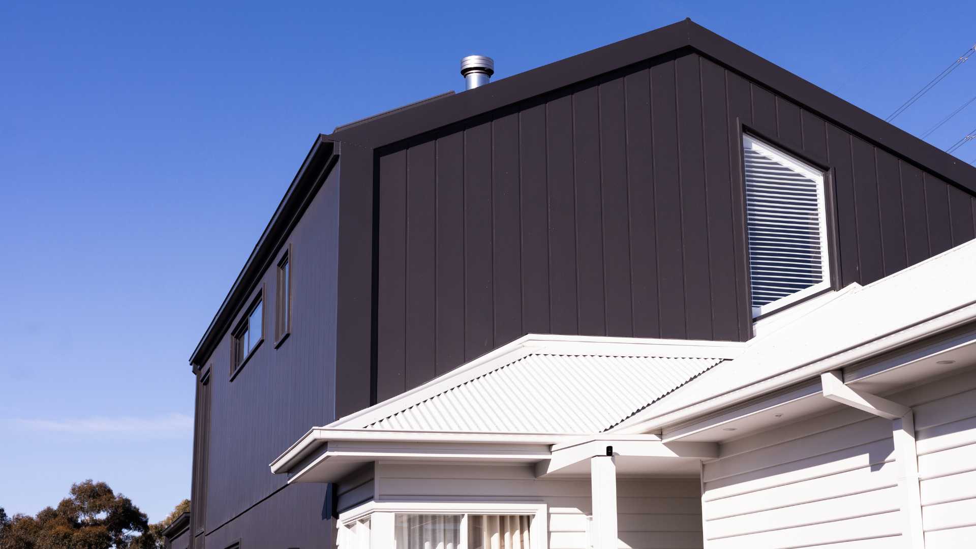 A modern house extension with horizontal wood cladding.