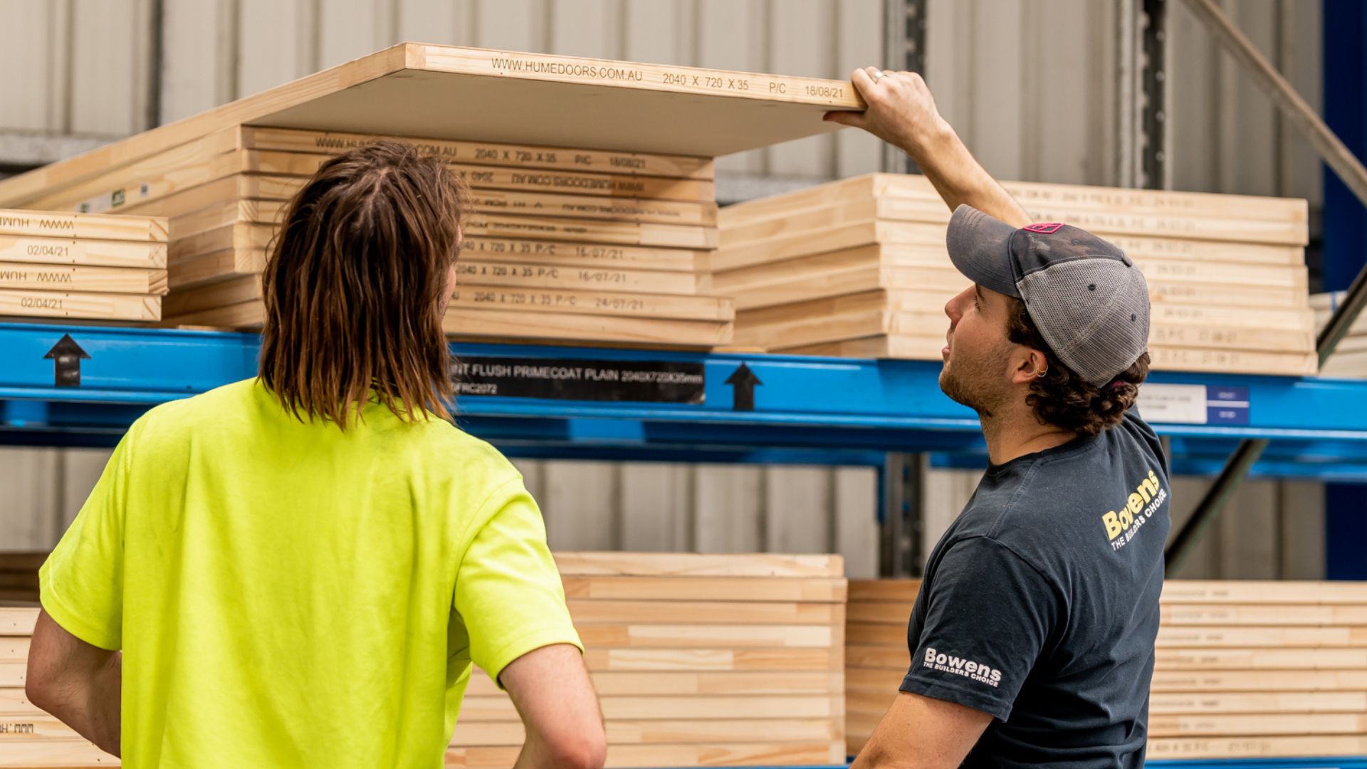 A Bowens staff member is assisting a customer with selecting the right internal door.