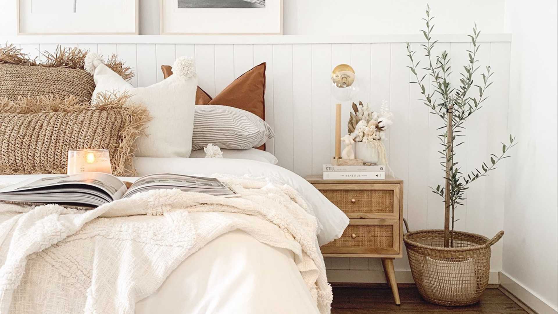 A cozy bedroom with a neatly made bed, a book resting on a nightstand, and a vibrant plant adding life to the Easycraft Silhouette interior wall lining.