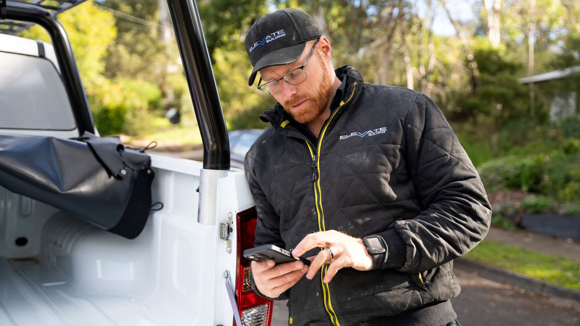 Builder using social media for their own business leaning next to their Ute.