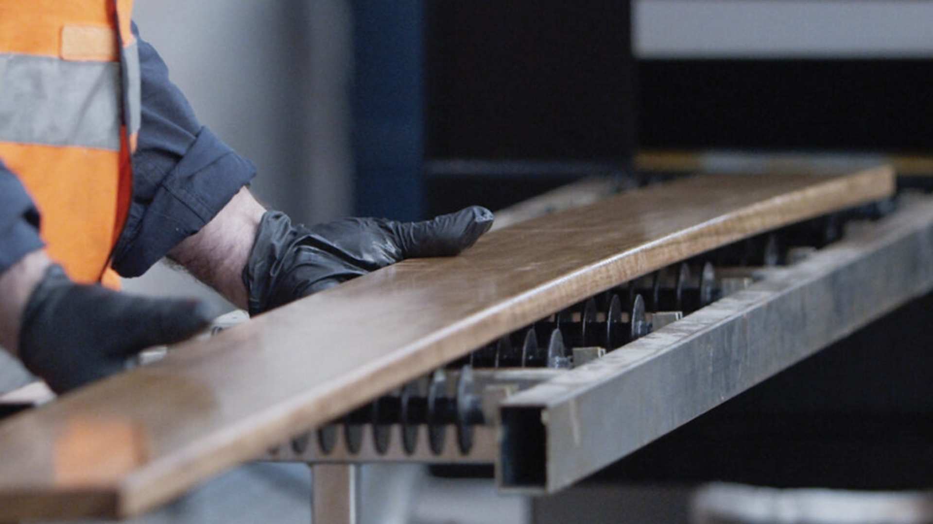 Timber during the pre-coating process in machine.