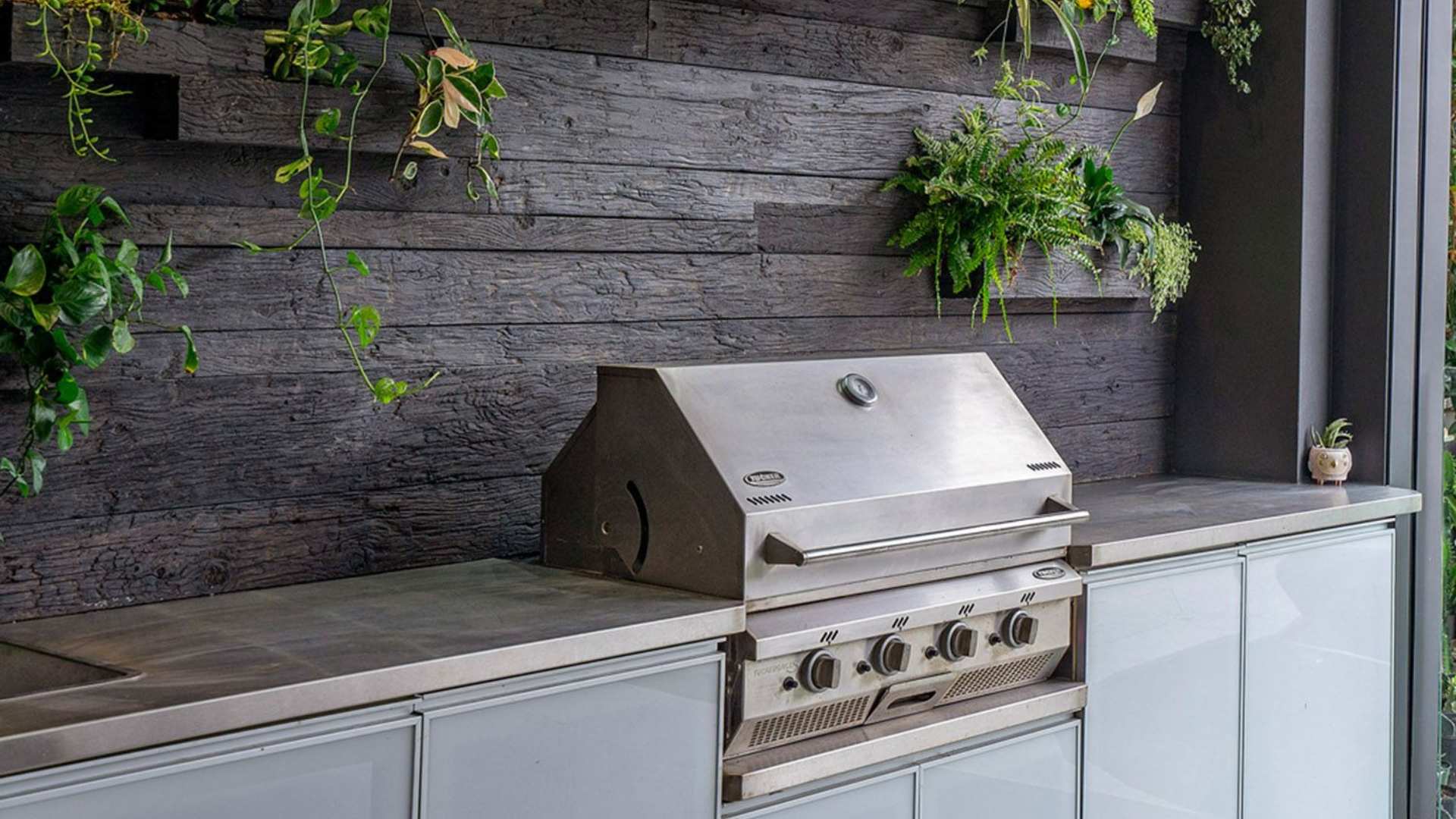 Millboard decking used on BBQ display with plants displayed nearby.