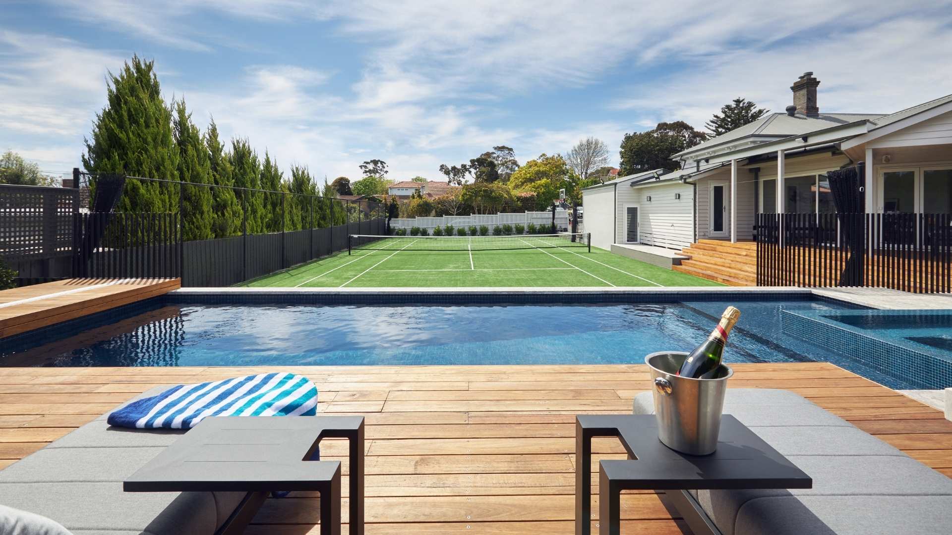 Silvertop ash decking, pool side and overlooking a tennis court.