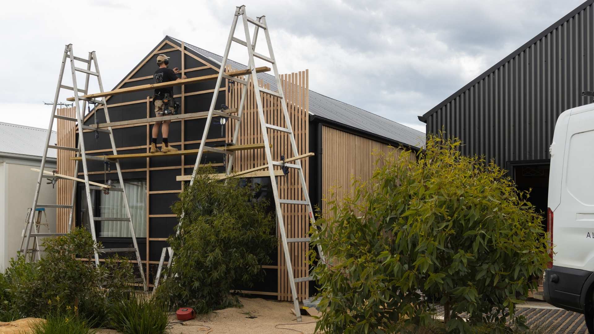 Al installing sustainable cladding on house project.