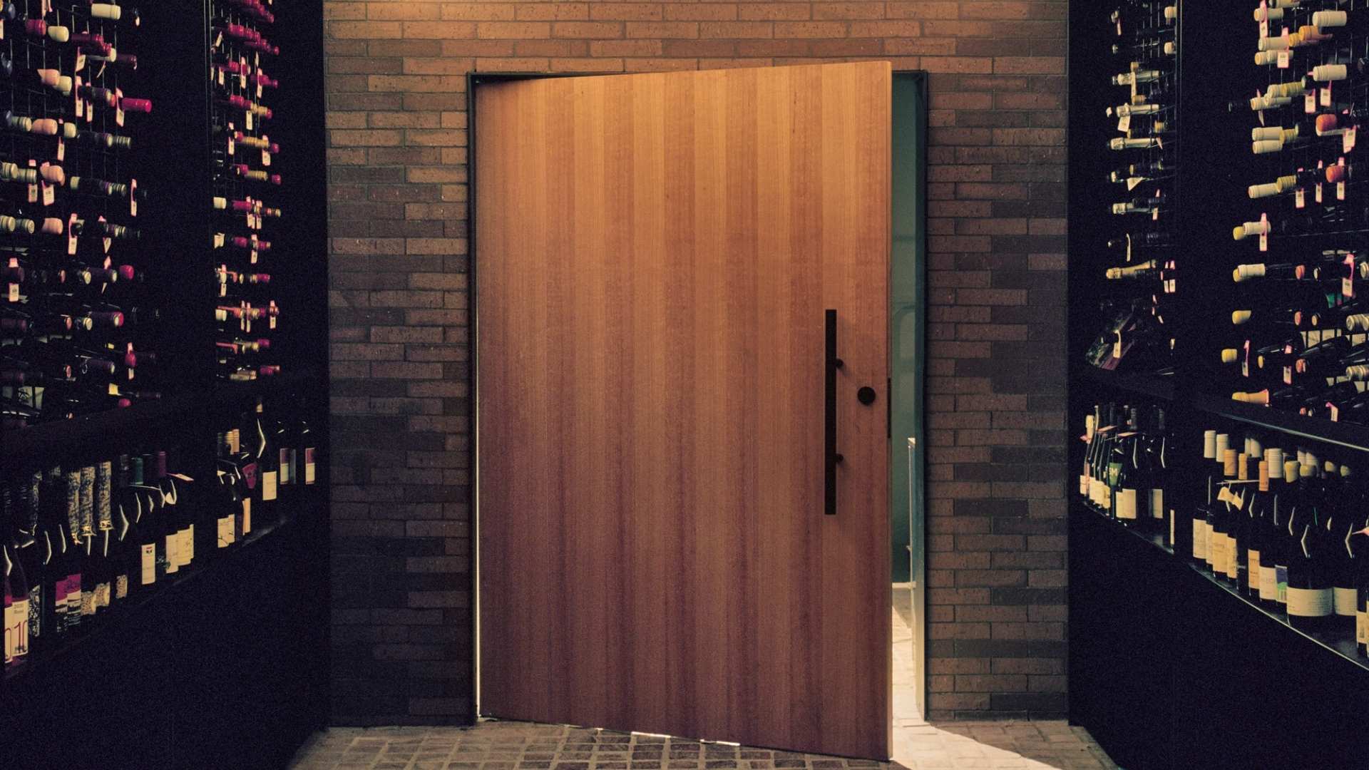 Pivot door displayed inside in wine cellar showcasing versatility of product.
