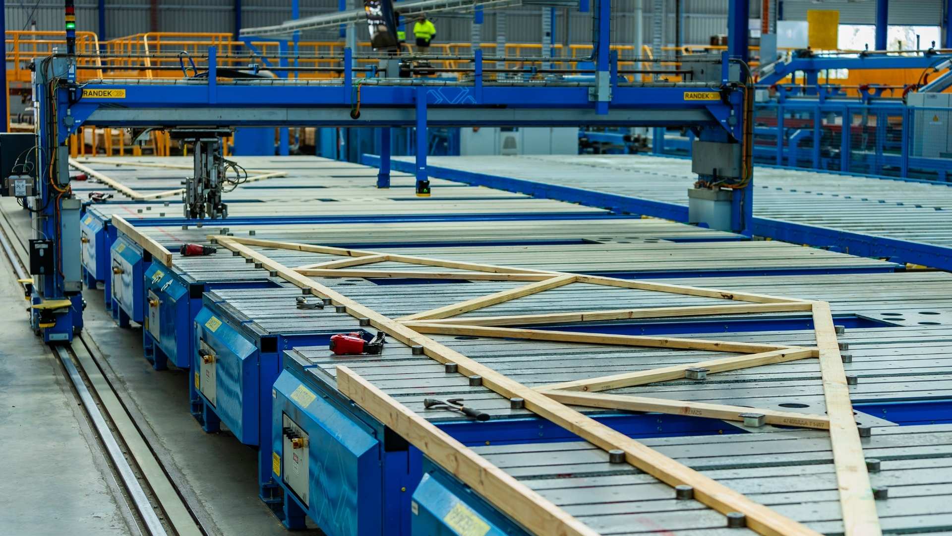Timber trusses during construction phase on assembly line.