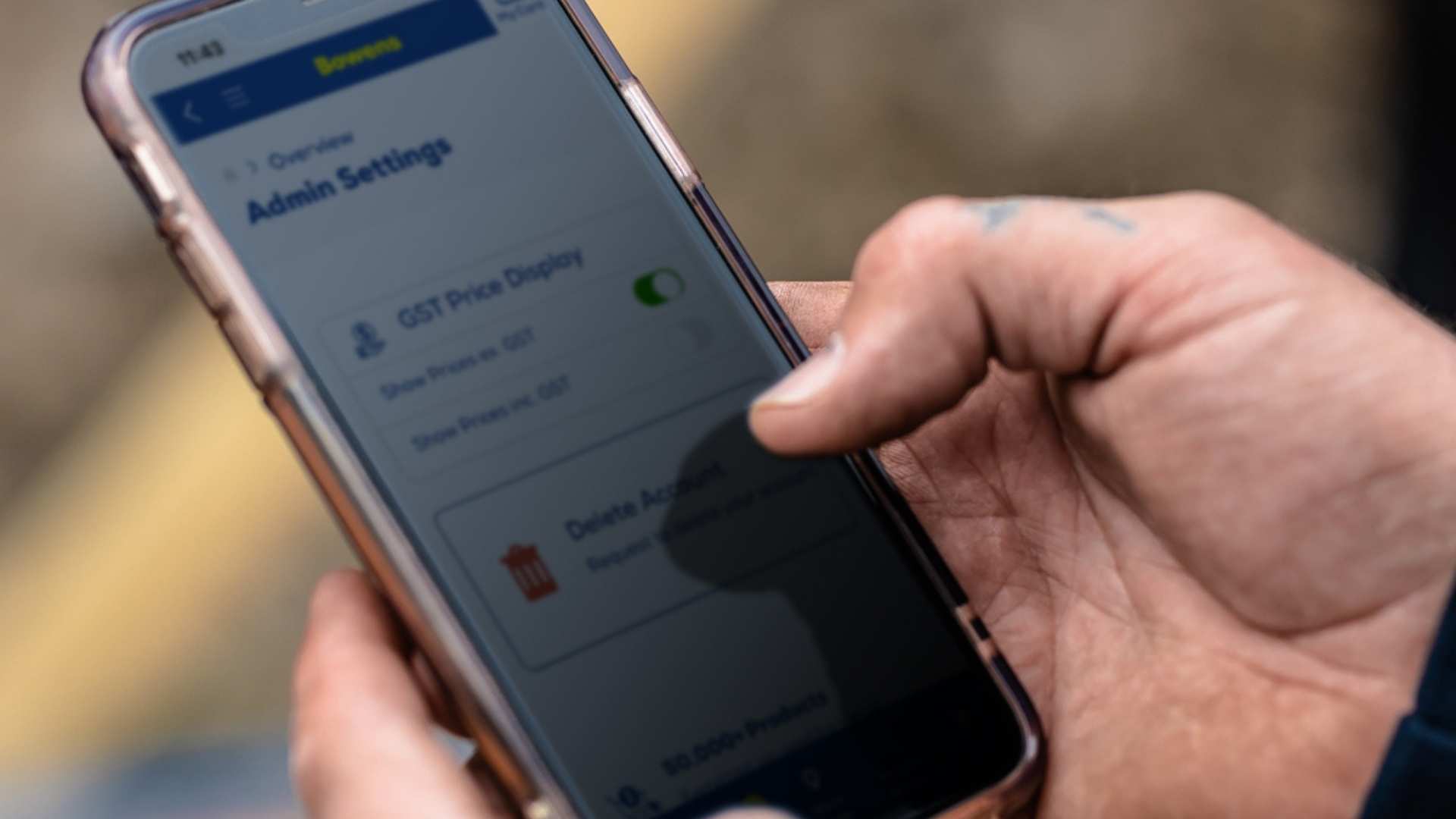 Close up shot of mobile phone looking at the new feature of toggle on/off GST pricing on Bowens App.