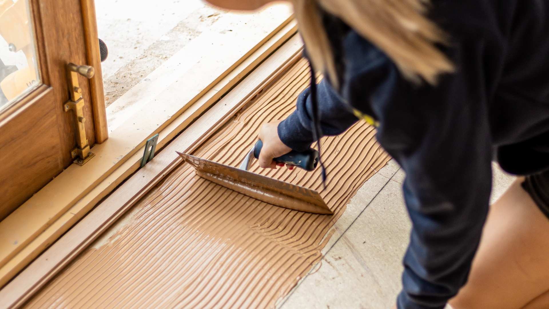 Ultraset Adhesive being applied before install of timber flooring.