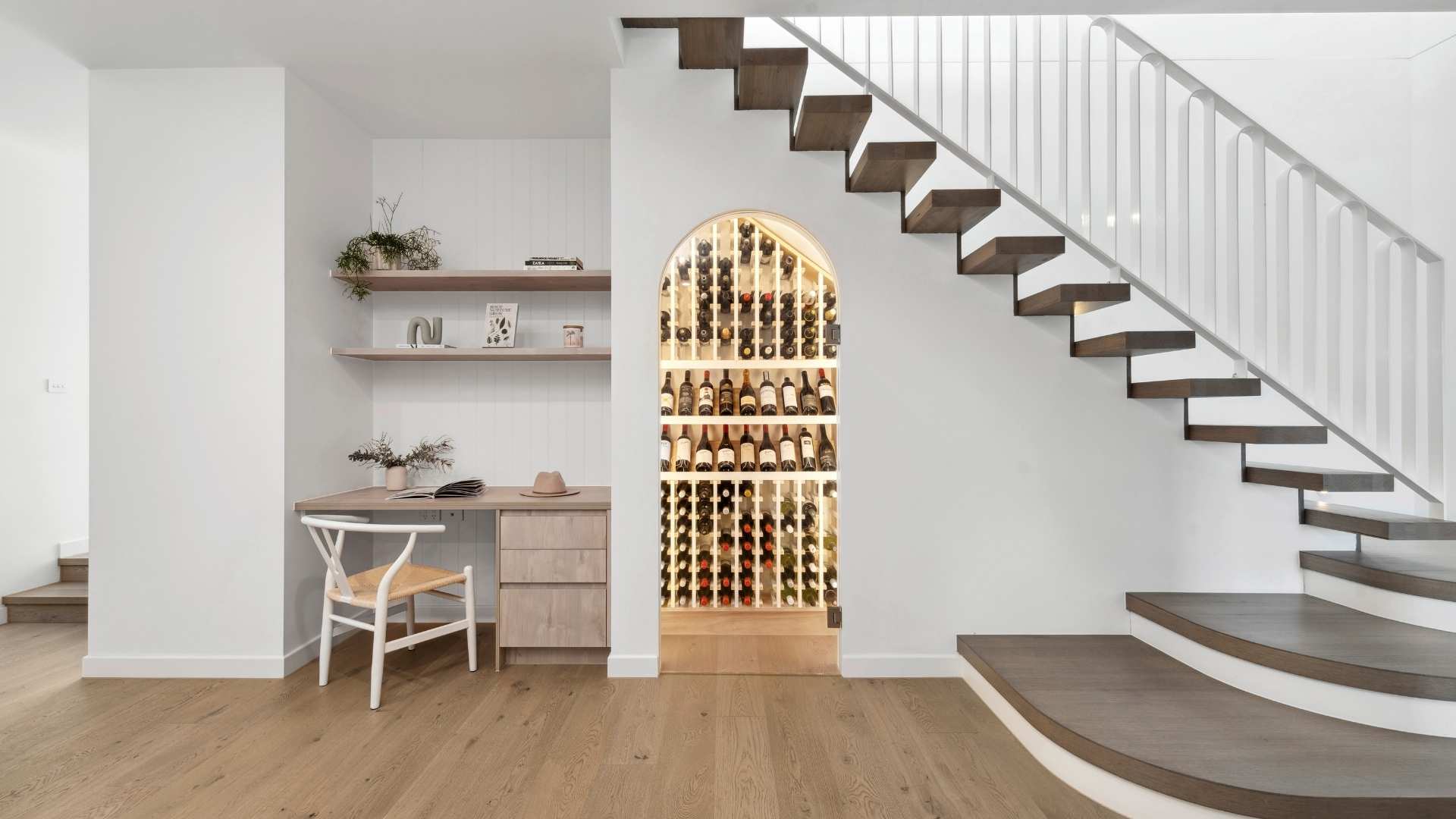 Wine cellar and desk underneath staircase.