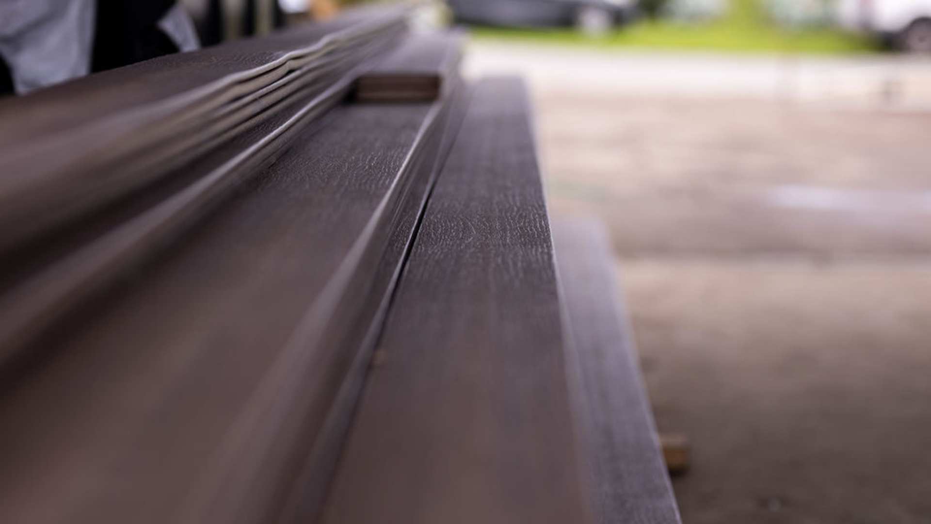 Composite decking boards stacked on top of each other prior to installation.