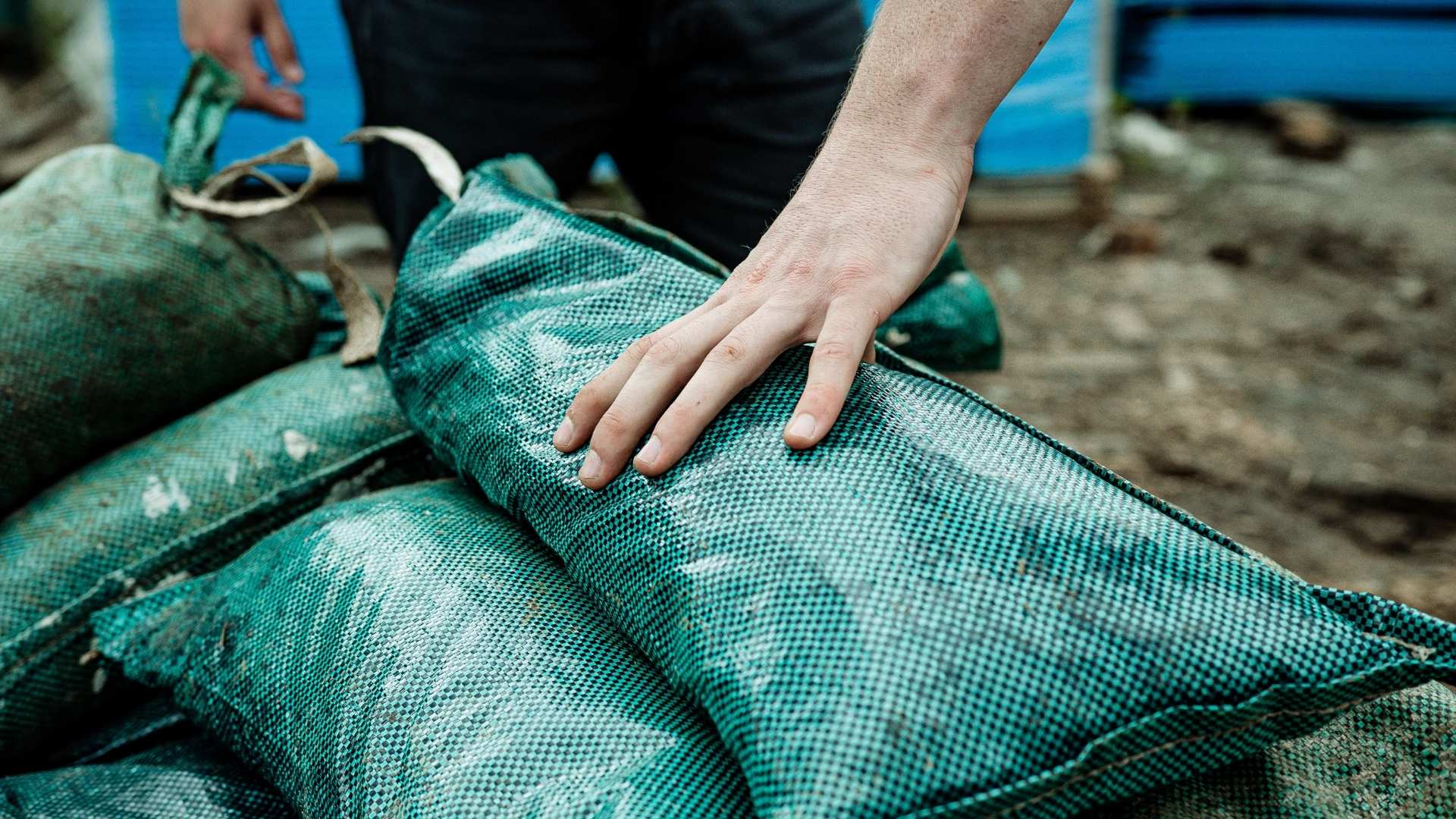 Trade selecting sandbags from Bowens hire.