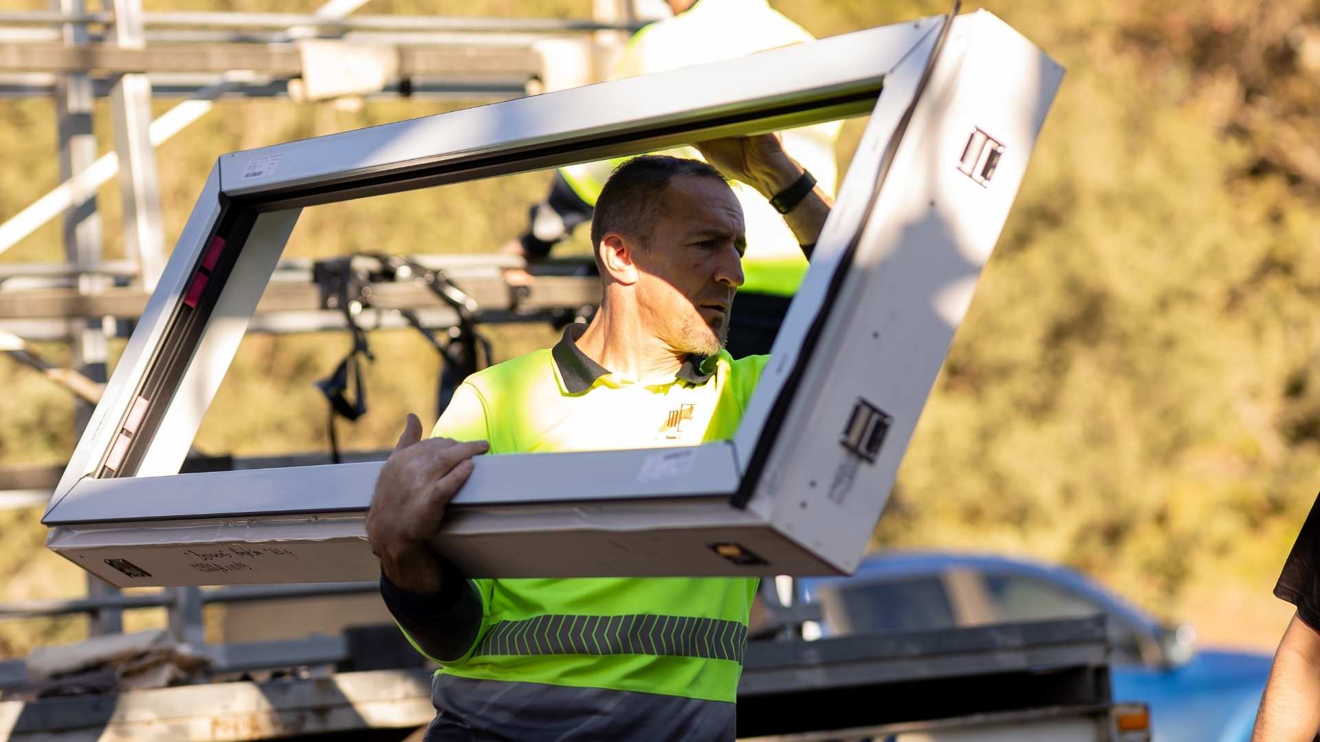 Thermotek worker bringing in clickin window system.