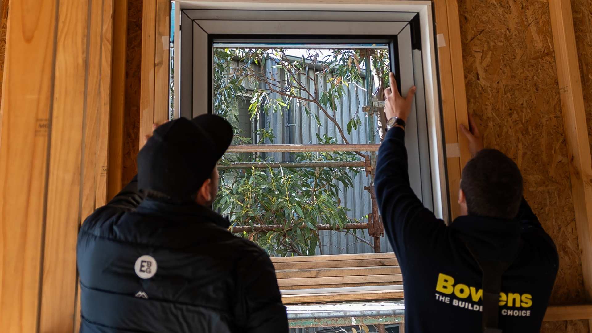 Two trades installing clickin window system on Anglesea job.