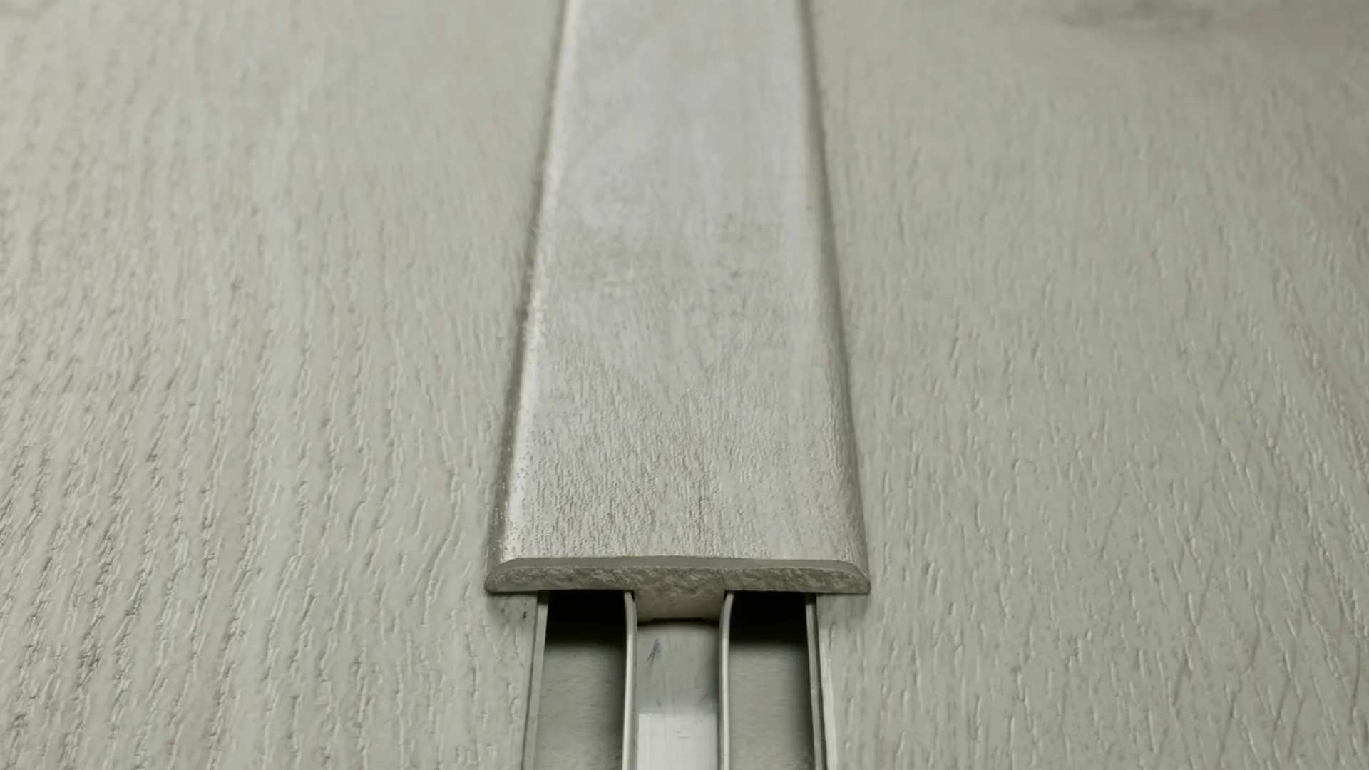 Close up shot of Dunlop® Heartridge Hybrid Flooring T-Mould.