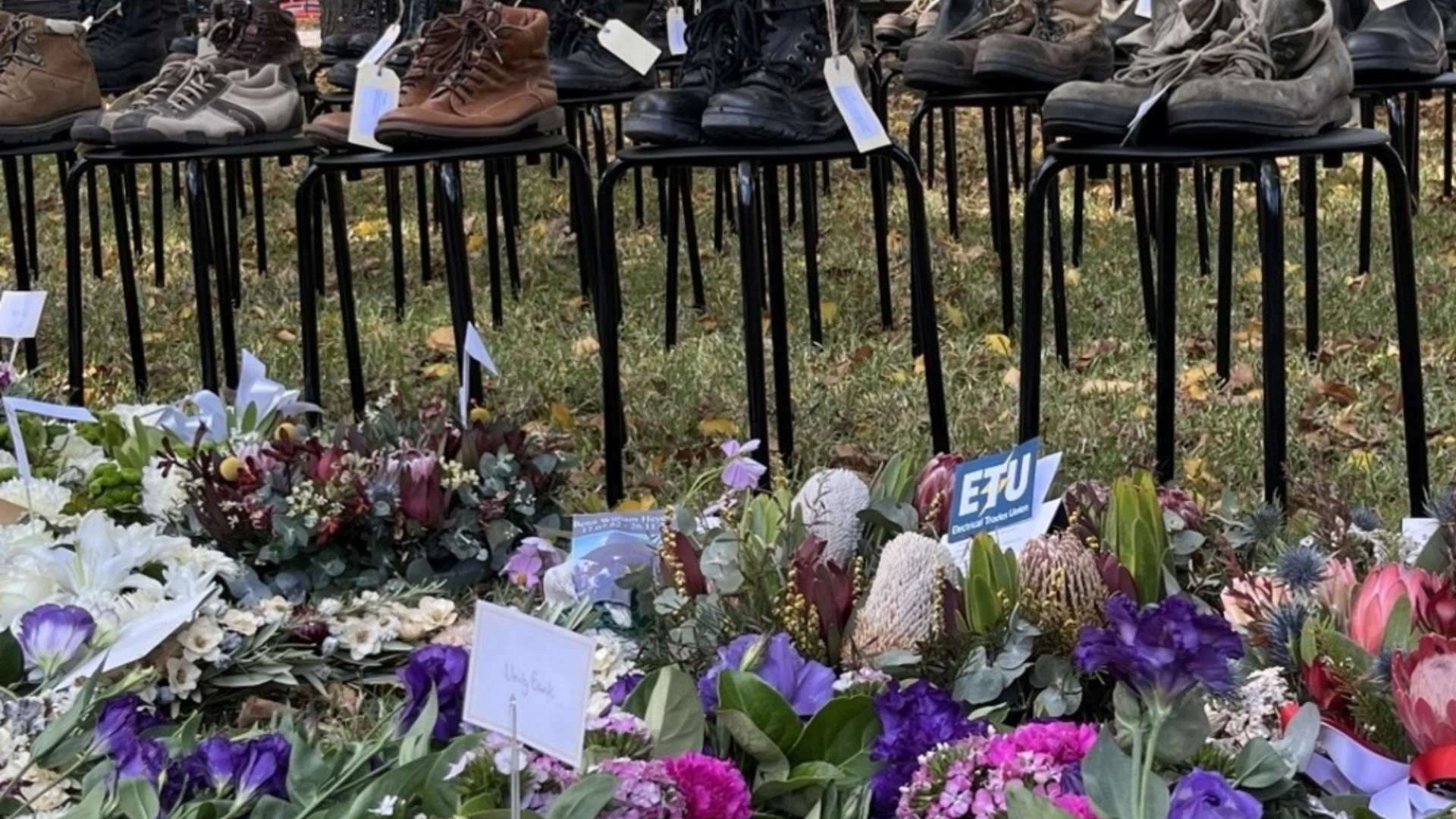 Memorial with flowers and shoes representing people who have passed.