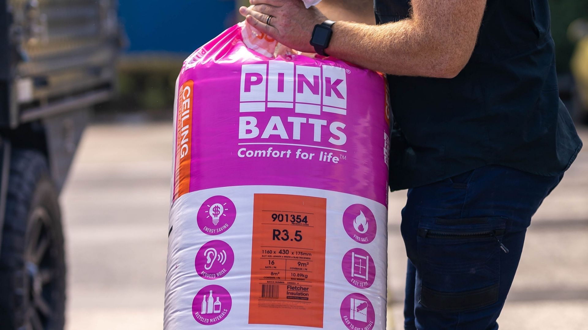 Trade holding Pink Batts Insulation.