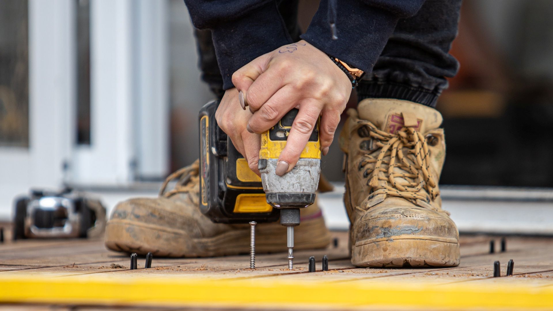 Screwing off a merbau deck with decking screws - the right fasteners for this project.